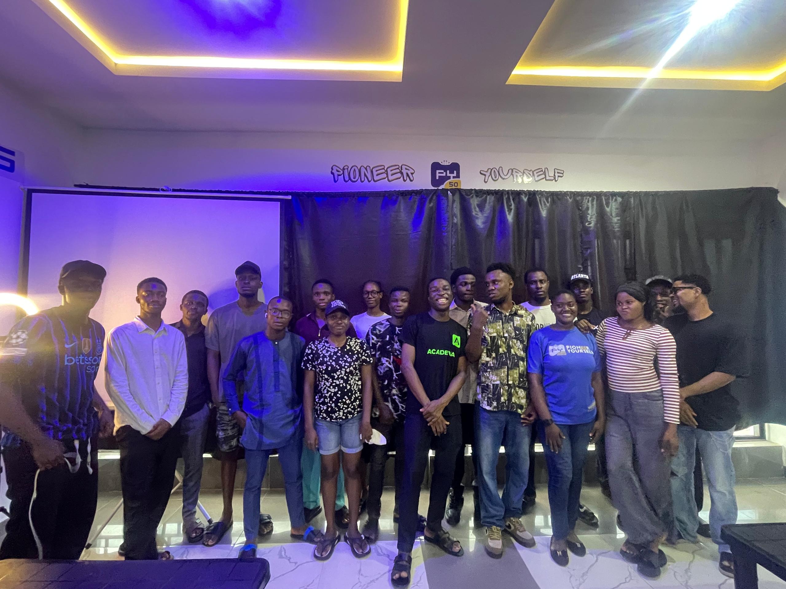 A PY50 cohort together under the Pioneer Yourself sign in Uyo, Nigeria